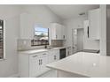 Modern white kitchen features quartz countertops, stainless steel appliances, and ample cabinet space at 1395 Kenneth Ave, Casselberry, FL 32707