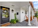 Inviting front porch with rocking chairs and landscaping at 2270 Deloraine Trl, Maitland, FL 32751