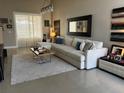 Bright living room featuring a large sectional sofa and a neutral color scheme at 5338 Los Palma Vista Dr, Orlando, FL 32837