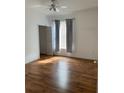 Bright bedroom with wood-look floors and gray curtains at 5500 Metrowest Blvd # 101, Orlando, FL 32811