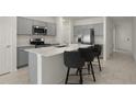 Modern kitchen featuring gray cabinets, a large island, and stainless steel appliances at 640 Reggie Rd, Winter Haven, FL 33884