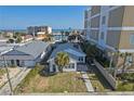 Charming beach home featuring a well-kept lawn, mature palm trees, and a paved walkway leading to the entrance at 718 N Grandview Ave, Daytona Beach, FL 32118