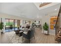 Bright living room featuring wood floors, a ceiling fan, and sliding glass doors to a screened patio at 7760 Windbreak Rd, Orlando, FL 32819