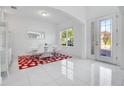 Modern dining room with white tile floors and red rug at 8298 Lookout Pointe Dr, Windermere, FL 34786