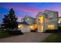 Two story house exterior view at dusk at 8298 Lookout Pointe Dr, Windermere, FL 34786