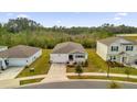 One-story house, aerial view showcasing neighborhood context at 9331 Revere Ave, Leesburg, FL 34788