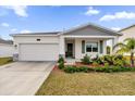 One-story house with attached garage and neatly landscaped front yard at 9331 Revere Ave, Leesburg, FL 34788