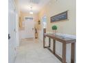 Bright and spacious entryway with tile floors and decorative console table at 1427 Wexford Way, Davenport, FL 33896