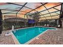 Enjoy the large pool, hot tub, and mounted TV under a screened-in lanai, perfect for outdoor entertainment and relaxation at 1427 Wexford Way, Davenport, FL 33896