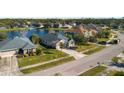 Aerial view of homes in a quiet suburban neighborhood with a serene lake and fountain at 164 Pergola Pl, Ormond Beach, FL 32174
