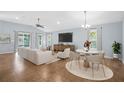 Bright and airy living room featuring tile floors, vaulted ceilings, and a dining area at 164 Pergola Pl, Ormond Beach, FL 32174