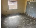 Empty bedroom with worn flooring and damaged walls, ready for renovation at 1804 Mable Butler Ave, Orlando, FL 32805