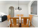 Dining room with a light-colored table and chairs, and a chandelier at 2303 Butterfly Palm Way # 201, Kissimmee, FL 34747