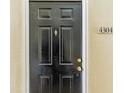 Black front door with brass hardware and address number 4304 at 231 Goldenrain Dr # 4304, Celebration, FL 34747