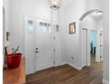 Bright foyer features wood-look floors, coat closet, and access to various rooms at 30810 Nocatee Trl, Sorrento, FL 32776