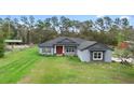 Inviting one-story home with a well-manicured lawn on a spacious lot at 30810 Nocatee Trl, Sorrento, FL 32776