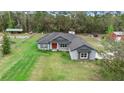 Landscaped one-story home featuring a well-kept lawn and neutral exterior at 30810 Nocatee Trl, Sorrento, FL 32776