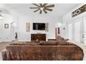 Spacious living room with high ceiling, fan, and seamless archway at 30810 Nocatee Trl, Sorrento, FL 32776