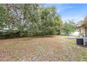 Large backyard with mature trees and a spacious area at 3608 N Westmoreland Dr, Orlando, FL 32804