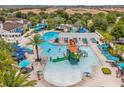 An aerial view of the community pool showcasing a splashpad, water slides, lazy river, and lounge area at 8824 Bengal Ct, Kissimmee, FL 34747