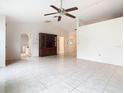 Living room with tile floors, ceiling fan and built-in hutch at 936 Gillingham Ct, Kissimmee, FL 34758