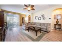 Spacious living room with hardwood floors and access to a patio at 9427 Komika Ln, Winter Garden, FL 34787