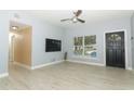 Living room with wood-look floors, and a view into the kitchen at 992 Carnation Dr, Winter Park, FL 32792