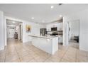 Open kitchen features island, stainless steel appliances, and granite countertops at 1016 Brooklet Dr, Davenport, FL 33837