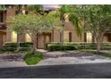 Evening view of a tan two-story townhome with landscaping and driveway at 120 Palermo St, Davenport, FL 33897