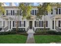 Three-unit townhome building with white exteriors and dark-colored doors at 1641 Lake Baldwin Ln, Orlando, FL 32814