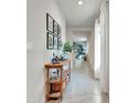 Bright entryway with a console table and picture frames at 1705 Bent Branch Ave, Deland, FL 32720