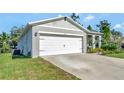 House exterior showcasing a white garage door and landscaping at 1705 Bent Branch Ave, Deland, FL 32720
