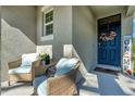 Front porch with wicker chairs and welcoming fall decor at 1705 Bent Branch Ave, Deland, FL 32720