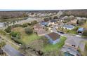Aerial view showcasing a house's location in a residential neighborhood near a lake and road at 2556 Volta Cir, Kissimmee, FL 34746