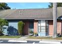 Brick condo front entrance with blue accents and landscaping at 2912 Squire Oak Ct, St Cloud, FL 34769