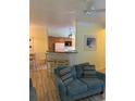 Cozy living room features a comfortable blue sofa and breakfast bar to the kitchen at 3006 Bonfire Beach Dr # 102, Kissimmee, FL 34746
