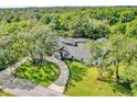 Luxury home with circular driveway and lush green surroundings at 304 E Greentree Ln, Lake Mary, FL 32746