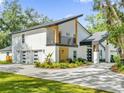 Contemporary home showcasing a sleek design and attractive landscaping at 304 E Greentree Ln, Lake Mary, FL 32746