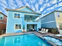 Two-story house with private pool, patio furniture, and hot tub at 3088 Parrot Head Pl, Kissimmee, FL 34747