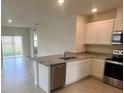Open-concept kitchen with stainless steel appliances, granite countertops, and abundant natural light at 3564 Fort Mellon Ln, Sanford, FL 32773