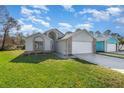 Two-story house with a white garage door and landscaping at 3846 Long Grove Ln, Port Orange, FL 32129