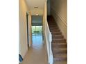 Inviting hallway with staircase leading to a pool and a bright living area at 430 Captiva Dr, Davenport, FL 33896