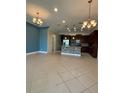 Bright open kitchen with tile floors, granite counters, stainless appliances and modern lighting at 430 Captiva Dr, Davenport, FL 33896