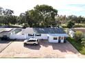 Single story home with paver driveway and mature tree in front at 5958 Lawnview Dr, Orlando, FL 32812