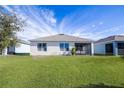 Spacious backyard with a covered patio and lush green grass at 613 Greymount St, Davenport, FL 33837
