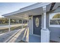 Dark gray front door with a glass oval accent at 613 Ross St, Leesburg, FL 34748