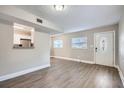 Bright living room with hardwood floors and kitchen view at 613 Ross St, Leesburg, FL 34748