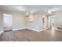 Open concept living area with hardwood floors and kitchen at 613 Ross St, Leesburg, FL 34748
