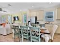 Farmhouse style dining table with six chairs, adjacent to kitchen at 8049 Lost Shaker Ln, Kissimmee, FL 34747