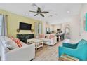 Open living room with light colored sofas and a view of the kitchen at 8049 Lost Shaker Ln, Kissimmee, FL 34747